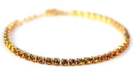 BRACCIALE TENNIS DORATO CON CRISTALLI COLOR CITRINO - maxifarmacia.it