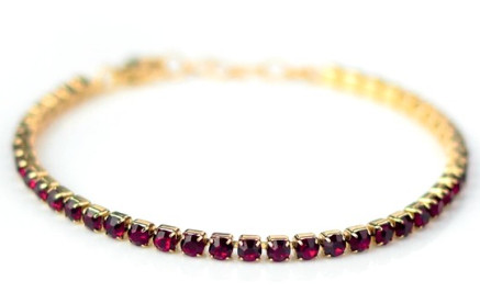 BRACCIALE TENNIS DORATO CON CRISTALLI COLOR RUBINO - maxifarmacia.it